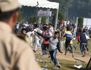 Srinagar: Youths throw stones and water bottles on police at the venue as violent clashes erupted during the first ever International Kashmir half-Marathon at Kashmir University Campus in Srinagar on Sunday. PTI Photo by S Irfan(PTI9_13_2015_000085A)